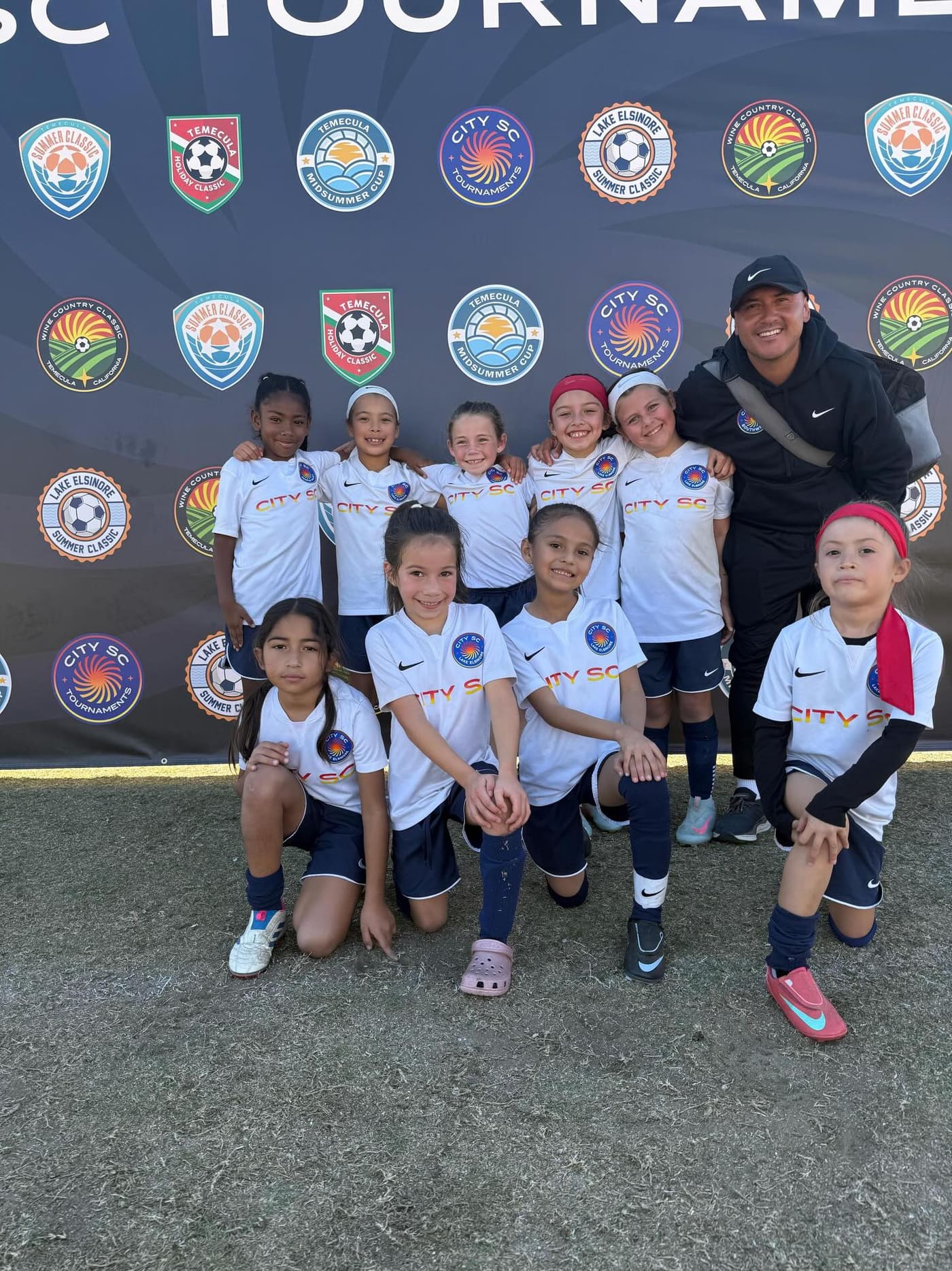 Coach Ceja with a girls team after a tournament